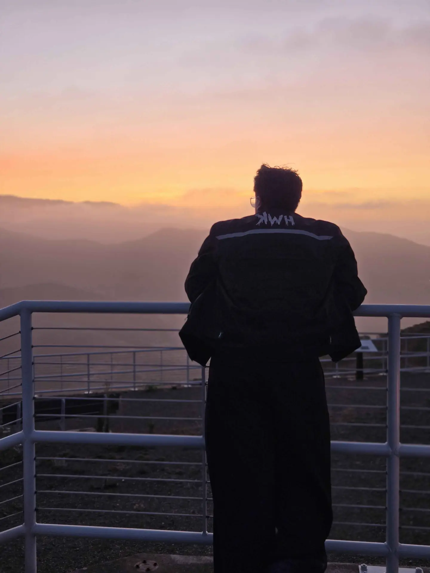 Ansh overlooking the mountains at sunset